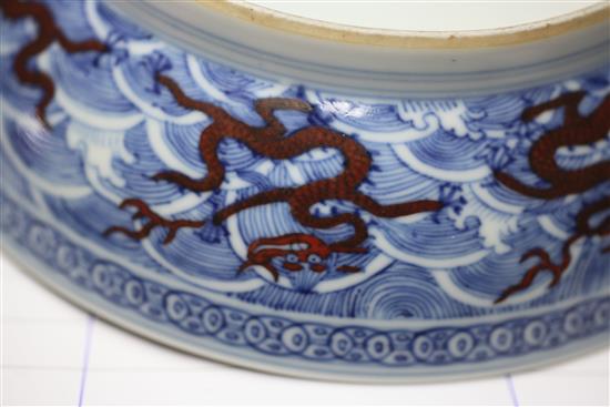 A Chinese iron red and underglaze blue dragon dish, Qianlong seal mark and of the period (1736-95), diameter 17.5cm, slight faults